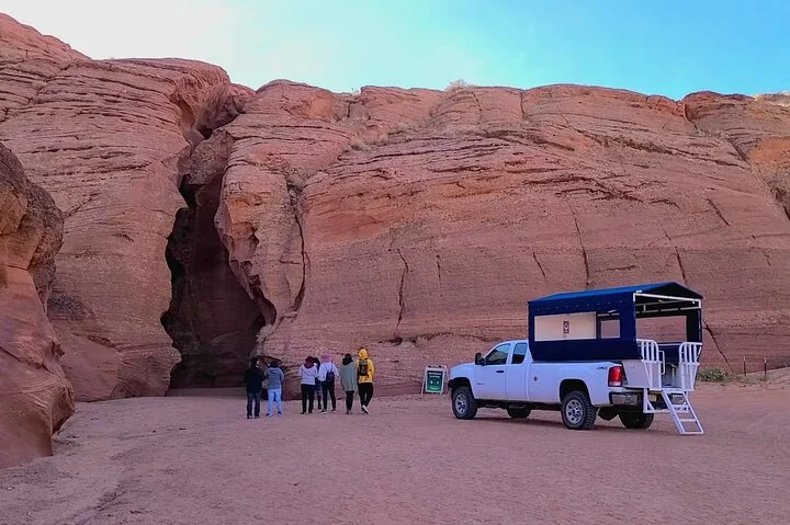 Tour group and vehicle at the entrance to Upper Antelope Canyon