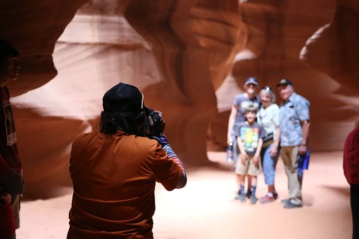 Guide photographing a family inside Upper Antelope Canyon