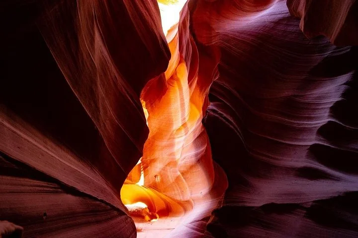 Glowing orange light between sandstone walls in Upper Antelope Canyon